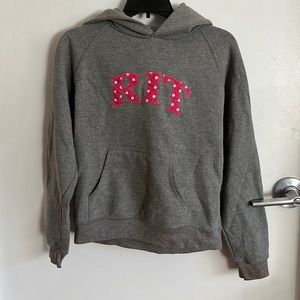 Grey Jansport hoodie with RIT logo in pink with polkadots